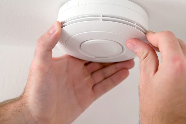 Smoke alarm being installed